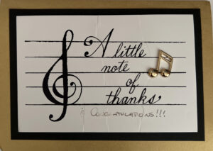 The cover of a thank-you note: words on a musical staff next to a treble clef: "A little note of thanks & congratulations!!!""